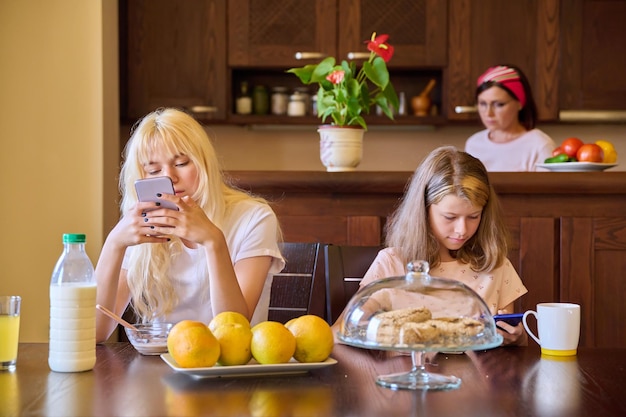 Family girls children eating at the table in the kitchen