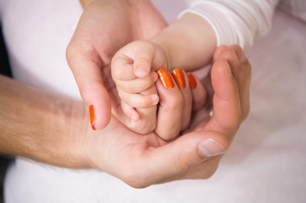 Family hands of father, mother and child together. Love, unity, support, protection, harmony concept