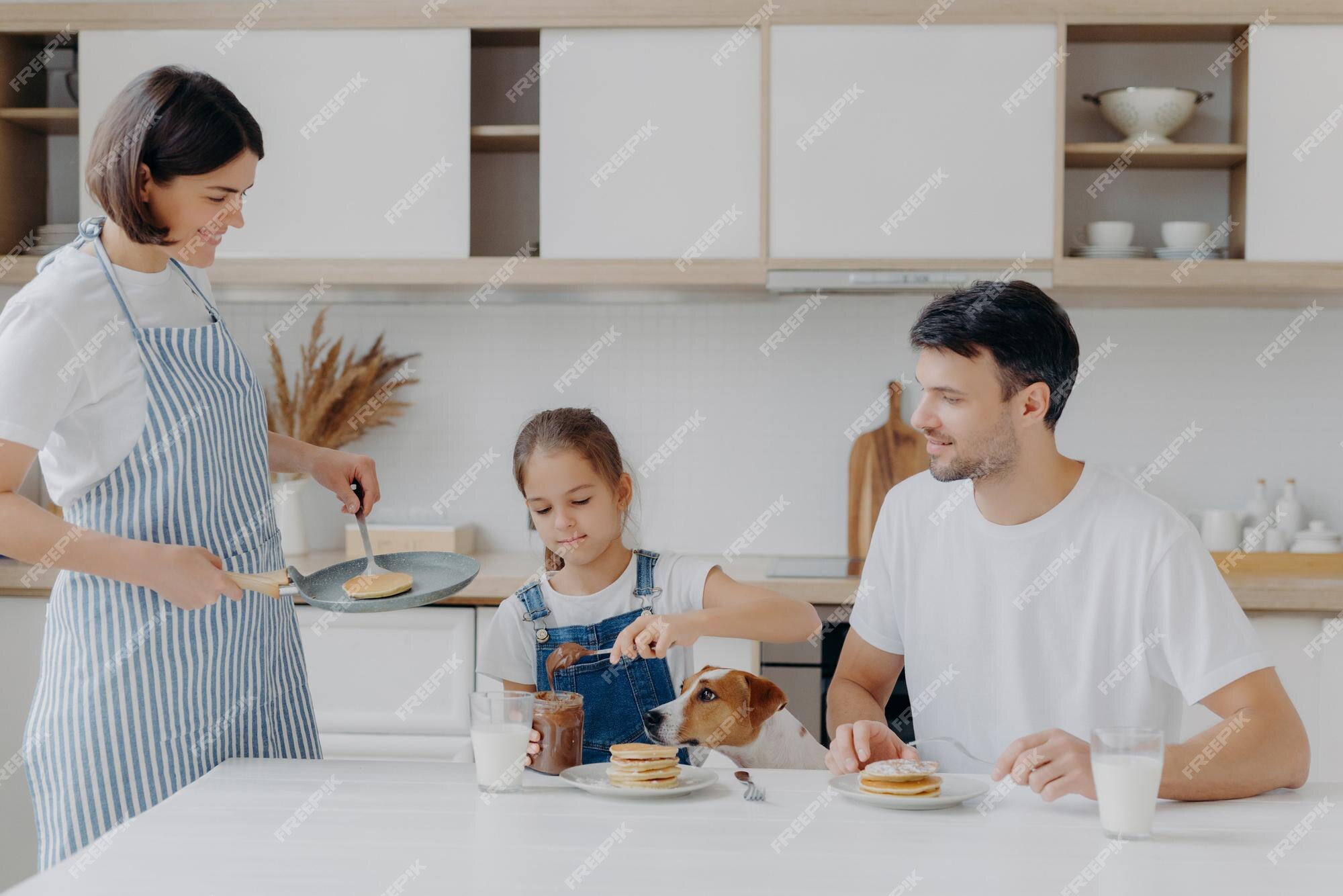 Premium Photo | Family have breakfast at kitchen in morning. happy girl ...