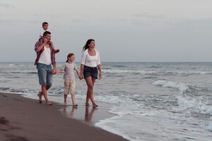 Photo the family have fun and live a healthy lifestyle on the beach. selective focus. high quality photo