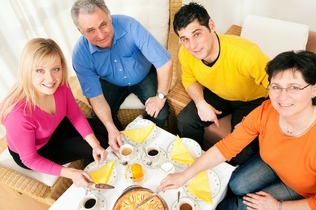 Family having coffee and cake together