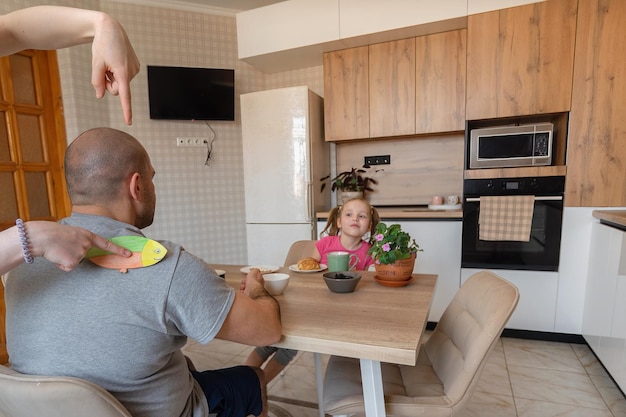 Family having fun having breakfast at home on the first of April