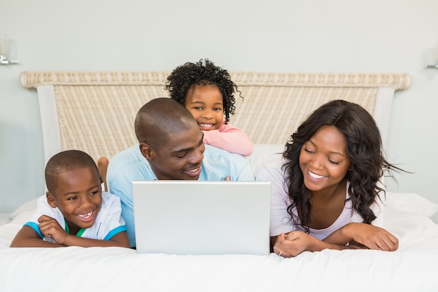 Family having fun together in bed