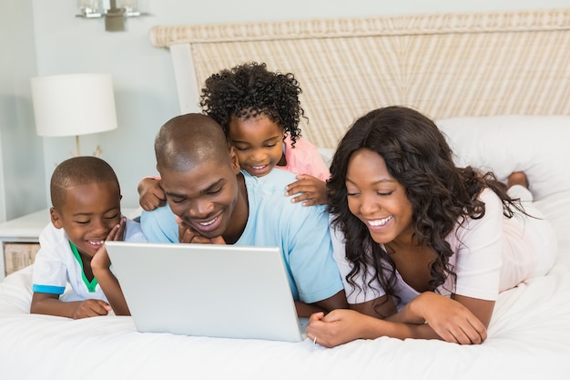 Family having fun together in bed