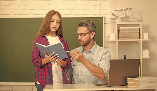 Family help dad and daughter use notebook back to school\
childhood education