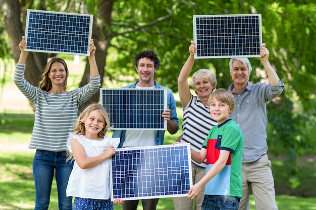 Family holding blackboard together