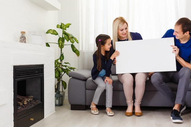 Photo family holds holds photo canvas at home