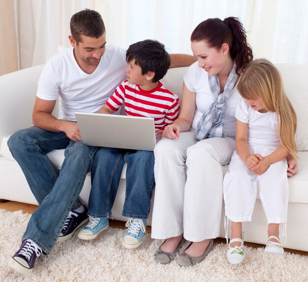 Family at home using a laptop