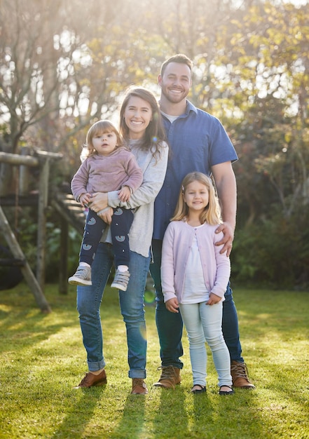 Family is everything Full length portrait of an affectionate young family of four posing in the garden at home