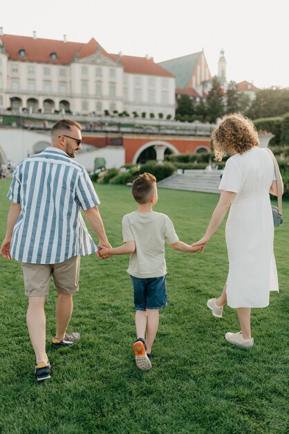 A family is strolling the garden of the palace in an old European town