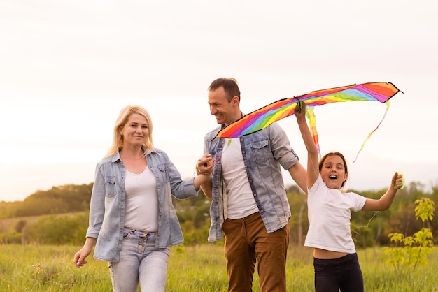 Photo family is walking in a field.