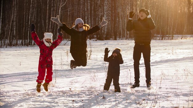 Family jumping up in the air outdoors at winter