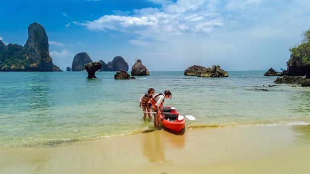 Family kayaking, mother and daughter paddling in kayak on tropical sea canoe tour near islands, having fun, active vacation with children in Thailand, Krabi