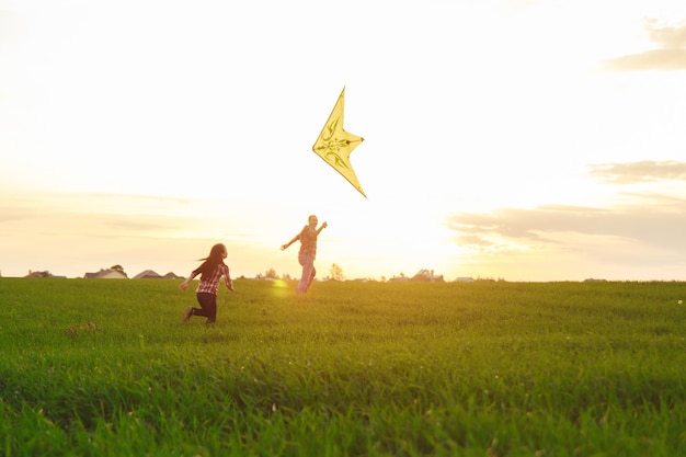 Family launches a kite in the field