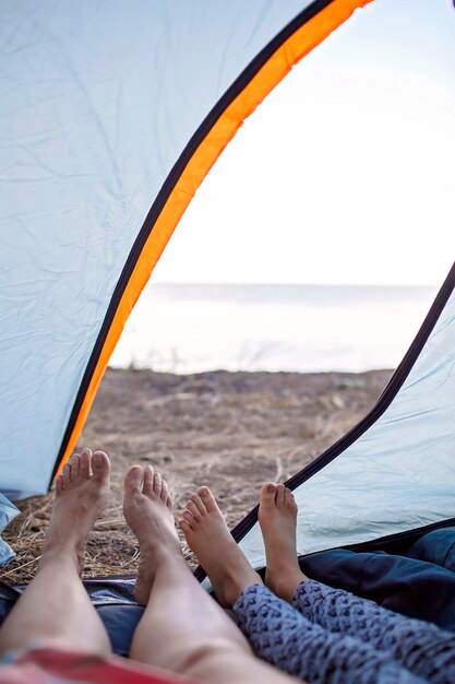 Family local getaway. Kid having rest in the camping tent at campsite, active lifestyle