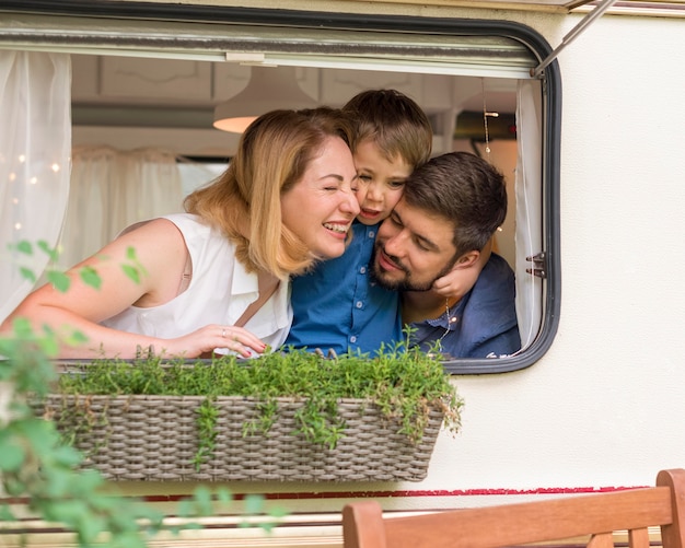 Family looking out of a caravan's window