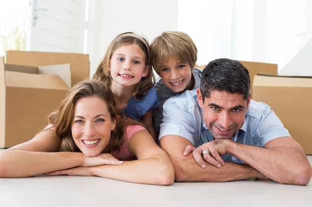 Family lying on floor in new house