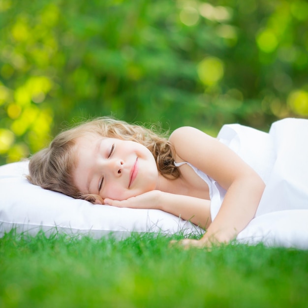 Family lying on green grass Children having fun outdoors in spring park