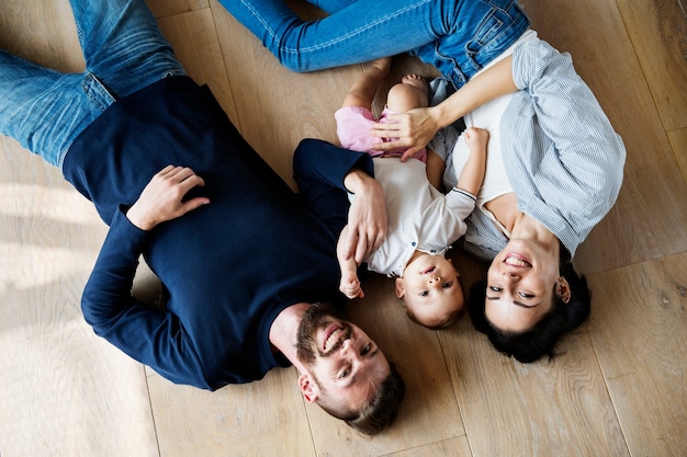 Family lying on wooden floor