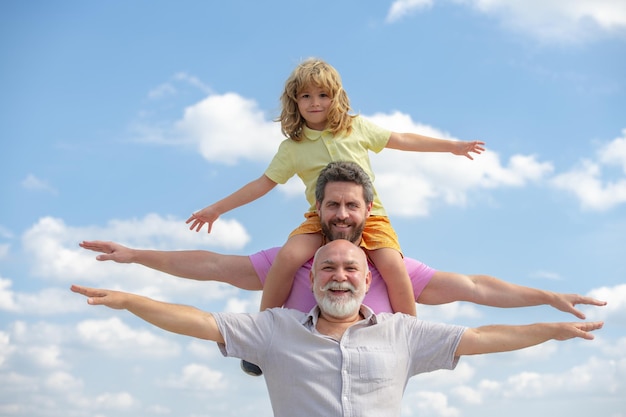 Family meeting father and a boy came to see his grandfather raising hands or open arms flying on sky