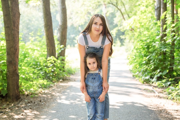 Family nature people concept  mother and daughter hugging in the park