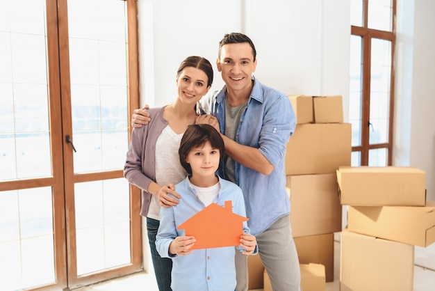 Family in new apartment with cardboard boxes.