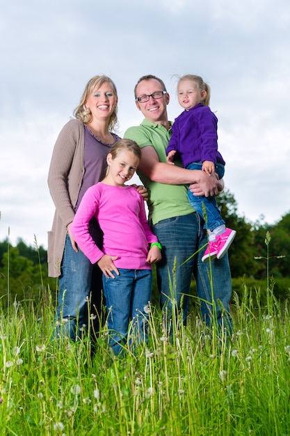 Family outdoors standing on grass