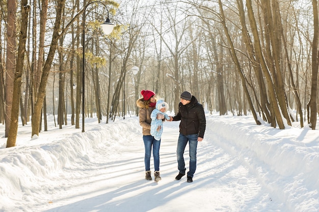 Family outdoors in winter landscape. Infant Baby