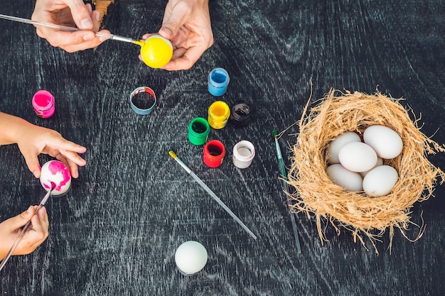 Family painting Easter eggs together