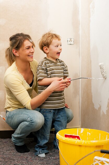 Family painting wall of new home