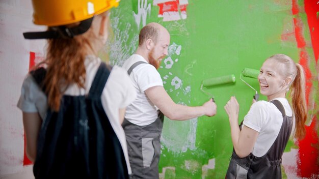 Family painting walls  little daughter looking at her smiling parents