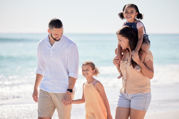 Family parents and kids walking on beach and bonding in trust love or security summer holiday Smile fun or happy mother and father with children or girls by Colombian ocean sea in tropical nature