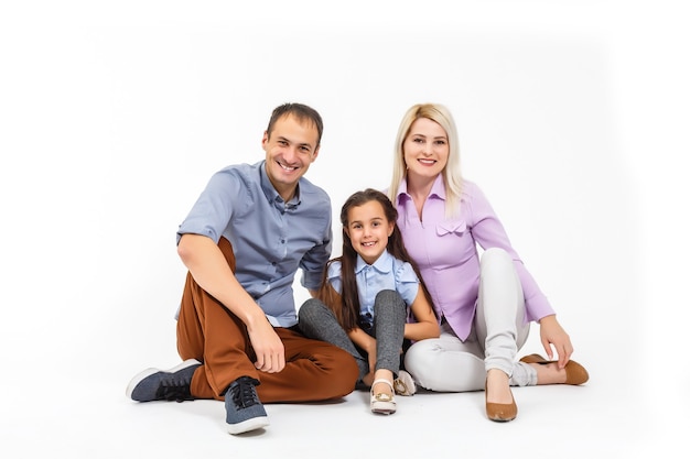 family and people concept - happy smiling mother, father and little daughter over white background