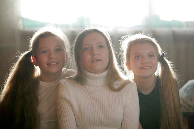 Family photo of sisters - three teen girls at home, close up