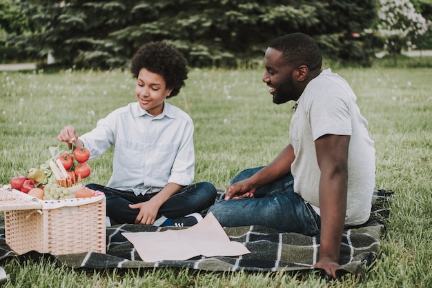 Family on Picnic and Boy Holding Tomatoes