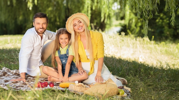 Family picnic Parents and daughter resting in nature