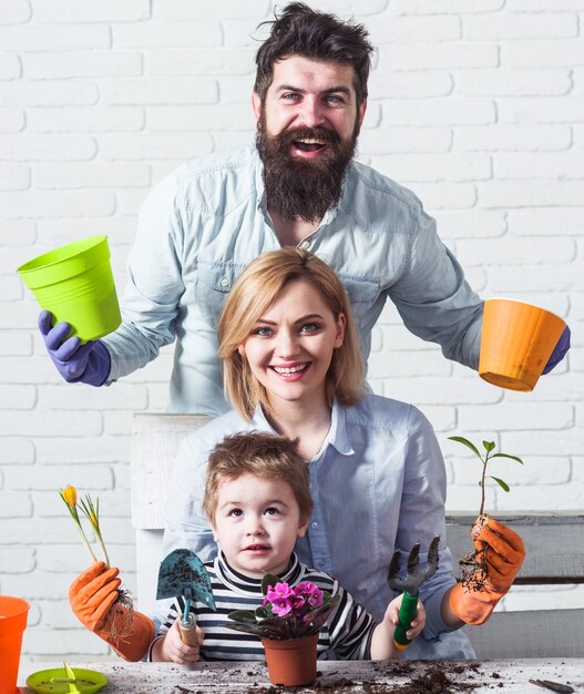 Family planting flowers together. Care for plants. Gardening concept.