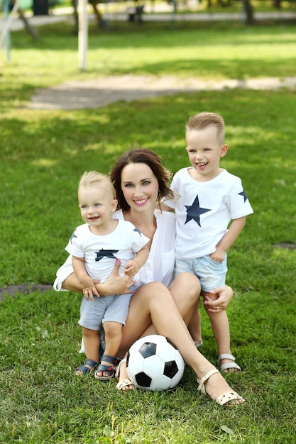 Photo family playing with the ball in summer park