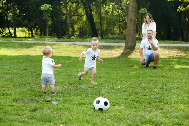 Family playing with the ball in summer park