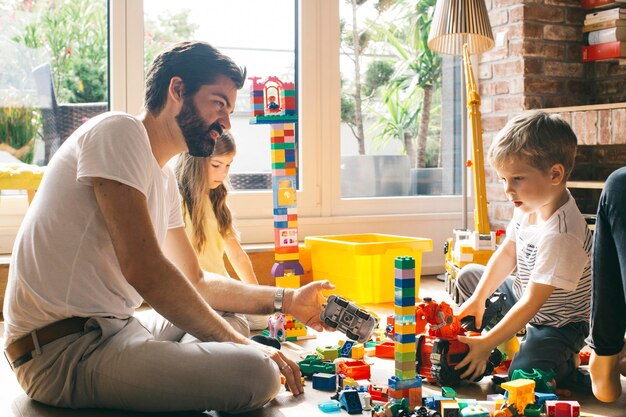 Family playing with building blocks on the floor together