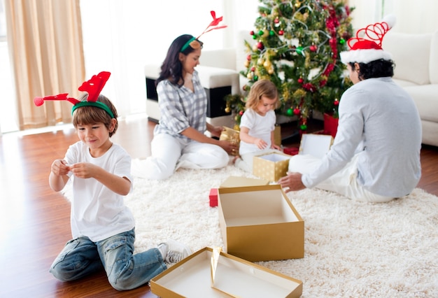 Family playing with Christmas gifts at home