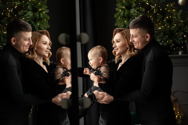 Family portrait. Christmas mood. Dark background