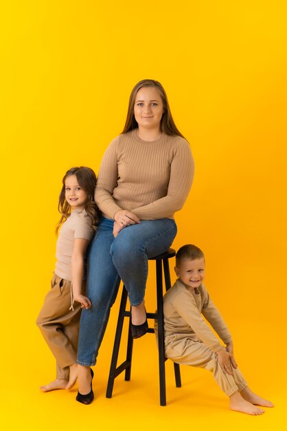 Family portrait of family mother daughter and son in the studio