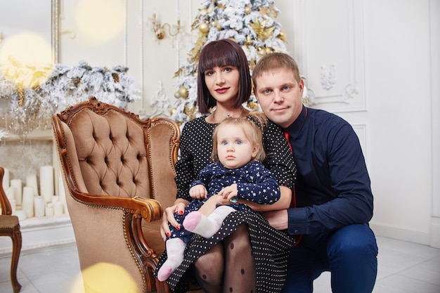 Family portrait of a mother with children on Christmas eve. New year at home with family