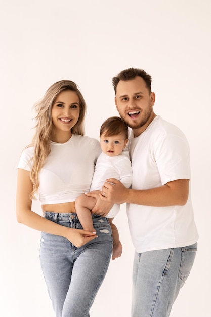 family portrait on a white background, happy family concept portrait. the parents play with the chil