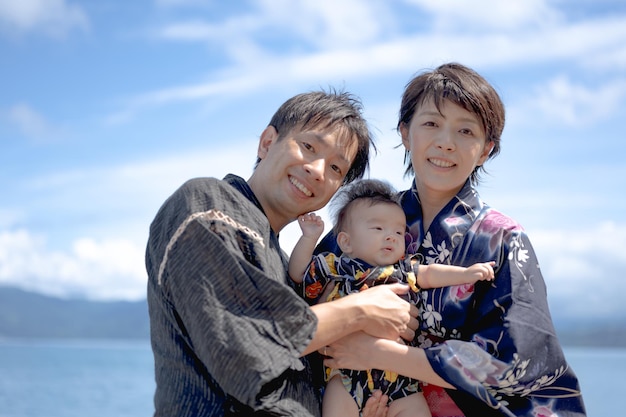 A family poses for a photo with a baby.