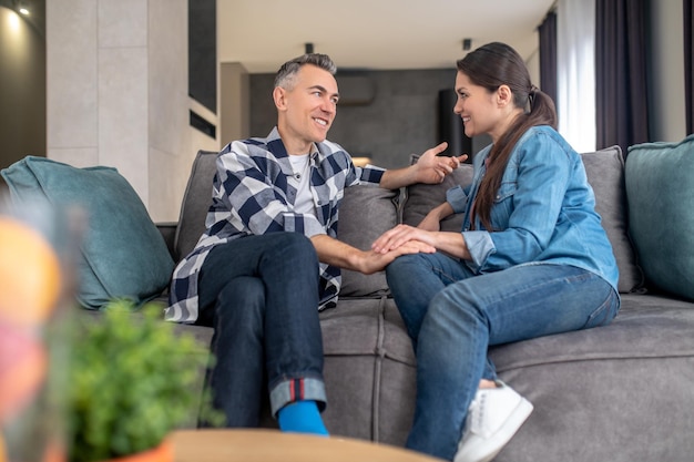 Family positive Profile of smiling woman looking at touching hand of rejoicing man