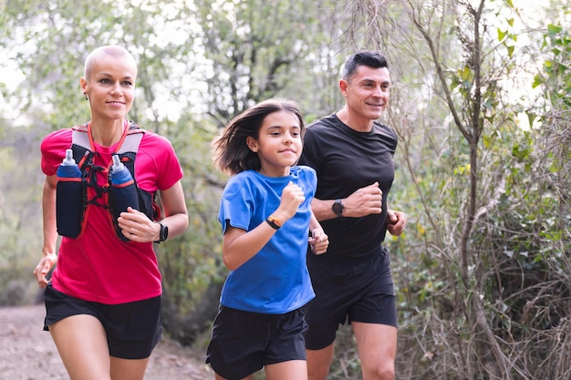 Family practicing trail running in the forest