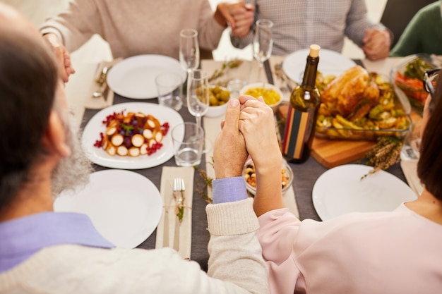 Family praying during dinner