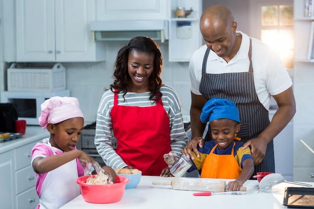 Family preparing cake